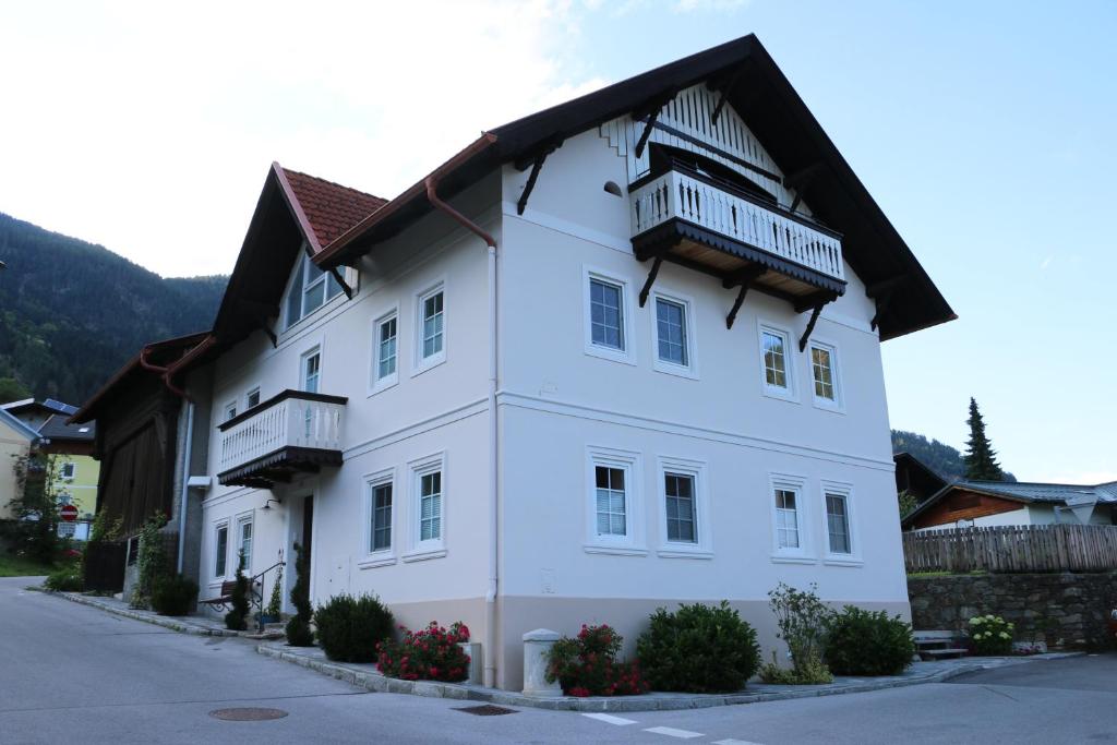 - un bâtiment blanc avec un balcon au-dessus dans l'établissement Ebners Träumerei, à Winklern