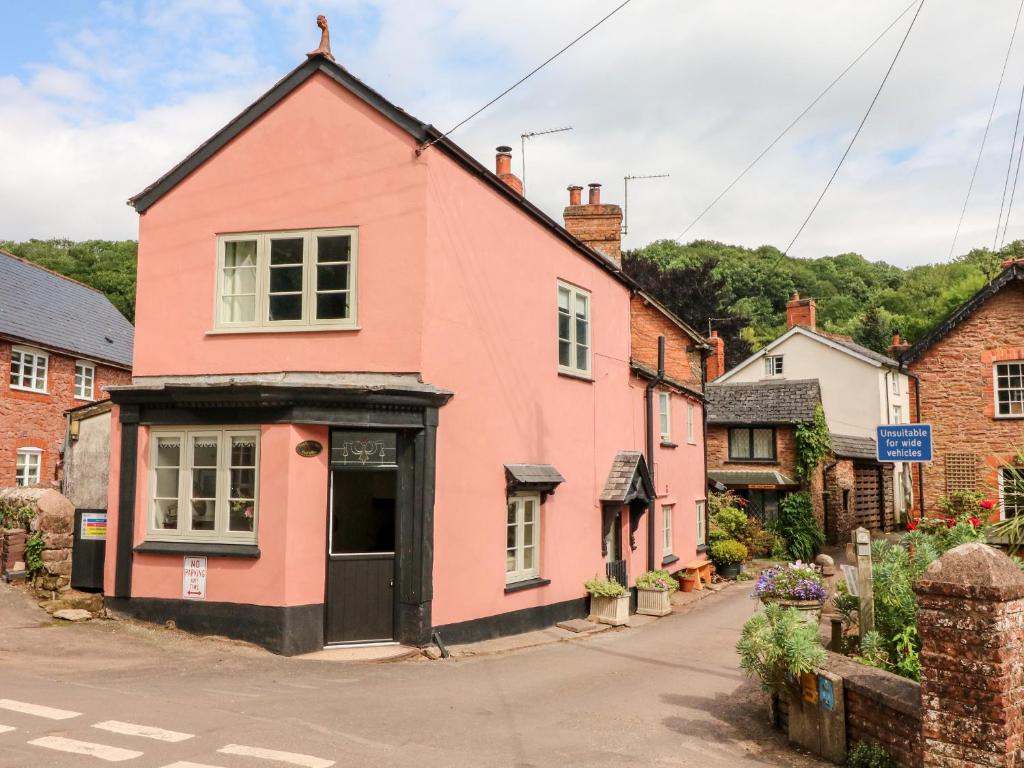 a pink house on the side of a street at Old Bridge Post Office in Watchet