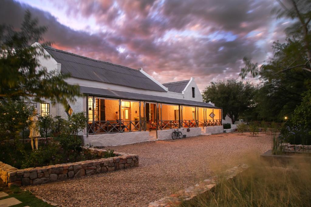 a house with a lot of windows on it at Dennehof Karoo Guesthouse in Prince Albert