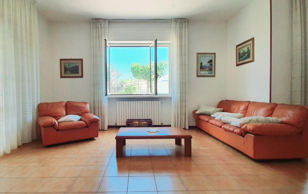 a living room with two couches and a coffee table at Villa nella collina Francavillese in Francavilla al Mare