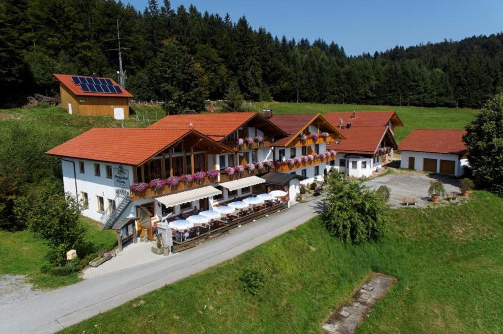 an aerial view of a large building with tables and chairs at Berggasthof-Pension Seminar- und Tagungshaus Menauer in Grandsberg