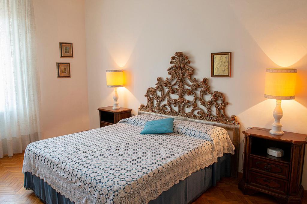 a bedroom with a bed with a blue pillow on it at Appartamento "Casa Mia" Florence in Florence