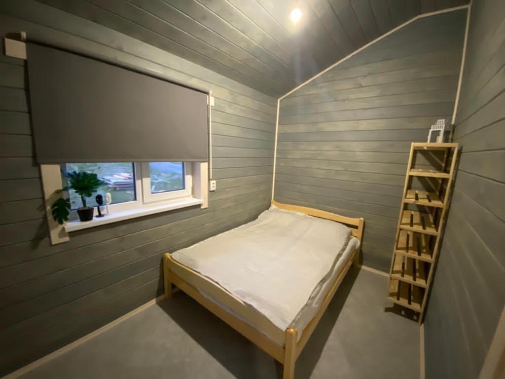 Кровать или кровати в номере Гостевые Домики у Озера