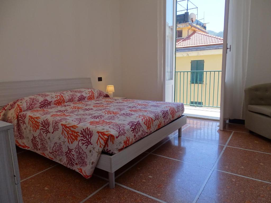 a bedroom with a bed and a large window at Casa Jacopo 50 mt dal mare in Levanto