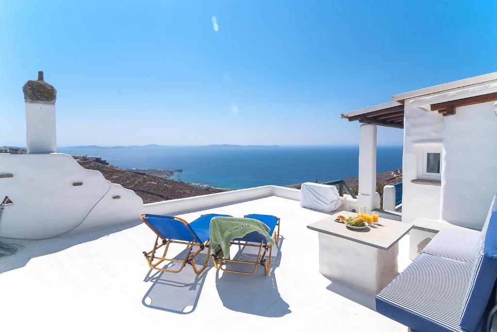 a balcony with two chairs and the ocean at Fanari sea view studios in Fanari