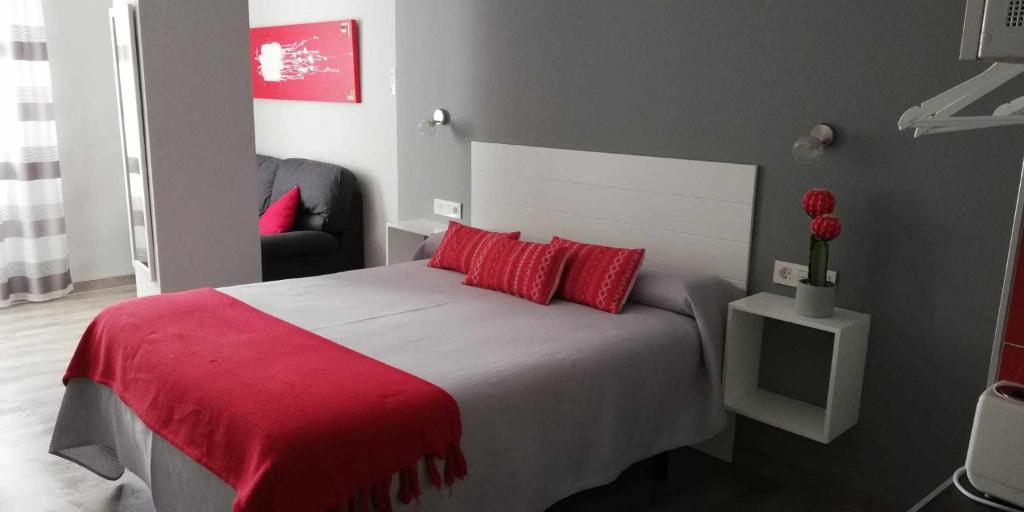 Posteľ alebo postele v izbe v ubytovaní Apartamentos Harmonia