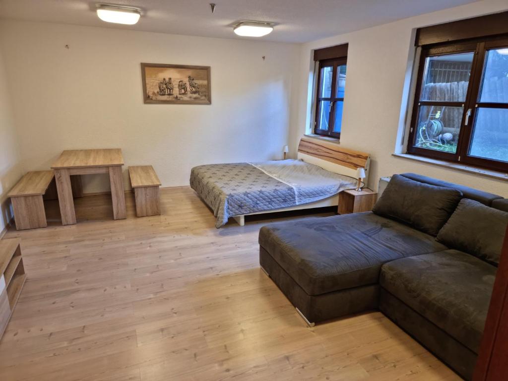 a living room with a couch and a bed at Citywohnung Tettnang in Tettnang