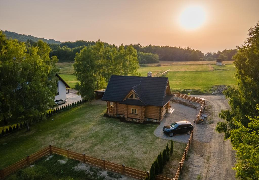 an aerial view of a log cabin with a car parked in the yard at BRZOZOWY SZELEST in Ustrzyki Dolne