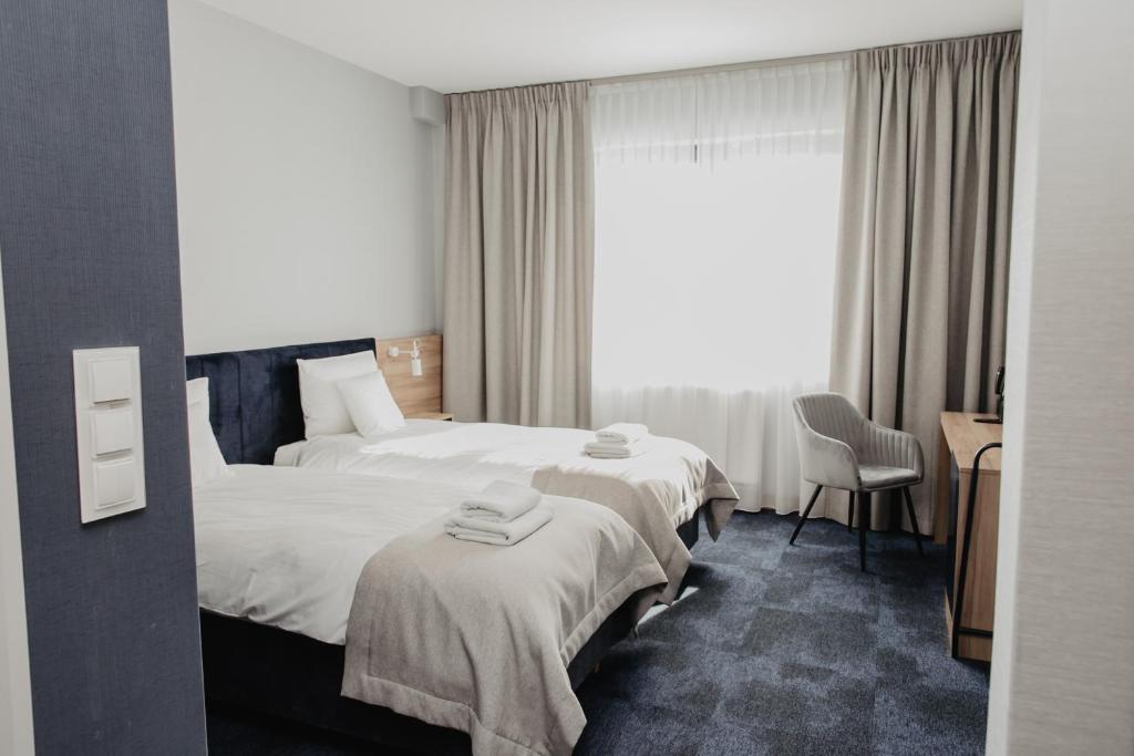 Posteľ alebo postele v izbe v ubytovaní Molto Bene Hotel & Restaurant