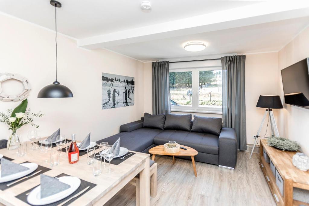 a living room with a couch and a table at Smart Resorts Haus Jade Ferienwohnung 201 in Winterberg