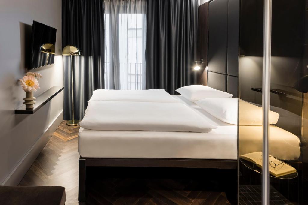 Postel nebo postele na pokoji v ubytování Hotel ROMY by AMANO