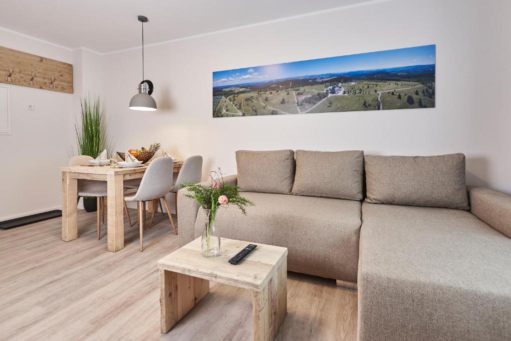 a living room with a couch and a table at Smart Resorts Haus Azur Ferienwohnung 808 in Winterberg