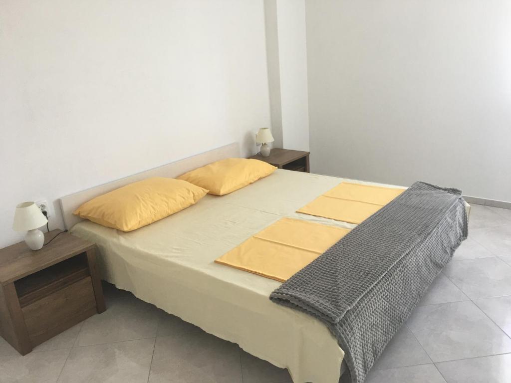 a bed with two pillows on it in a room at Apartments MiaMaja in Novalja