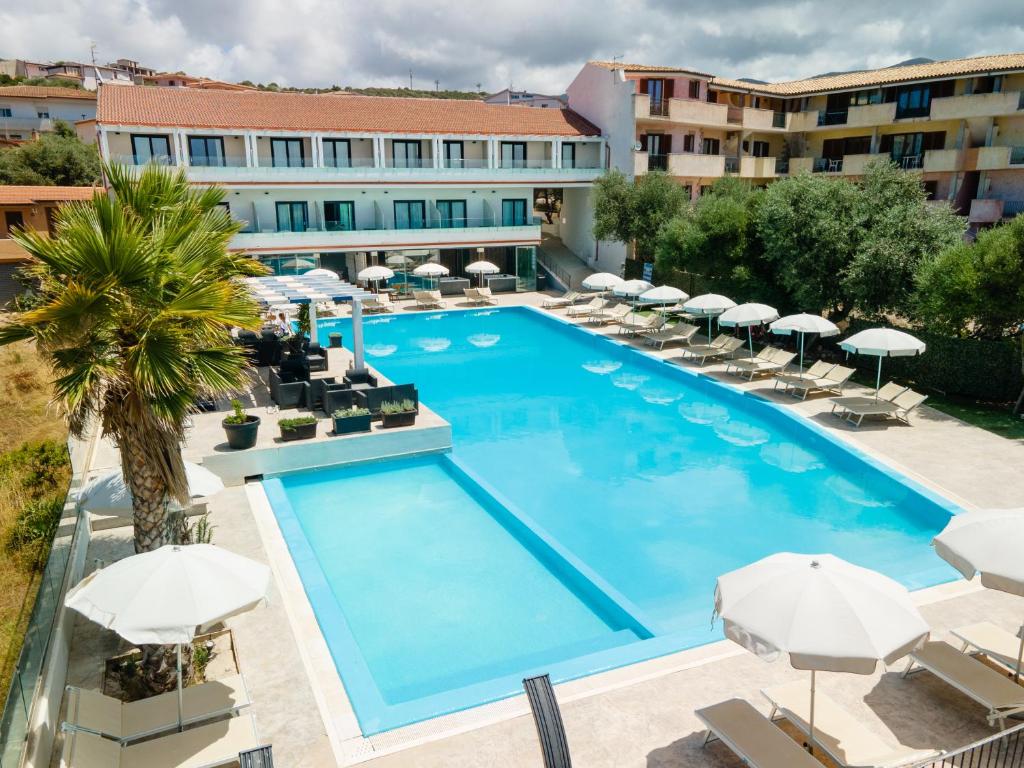 una vista aérea de una piscina con sillas y sombrillas en Horizon Hotel Badesi en Badesi