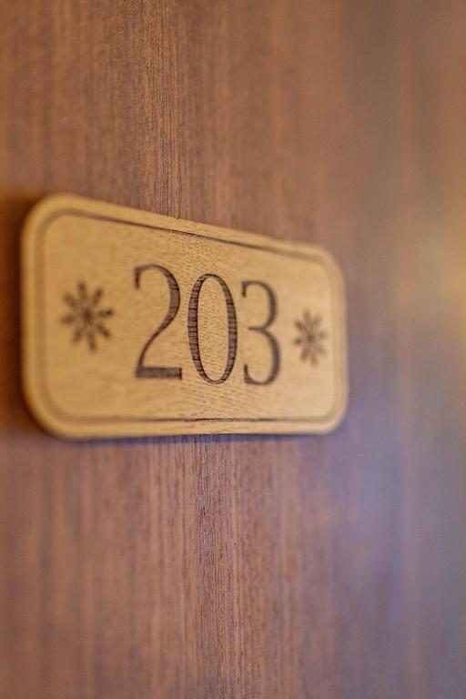 a wooden door with the number on it at L'Escale (accès en télécabine) in Châtel