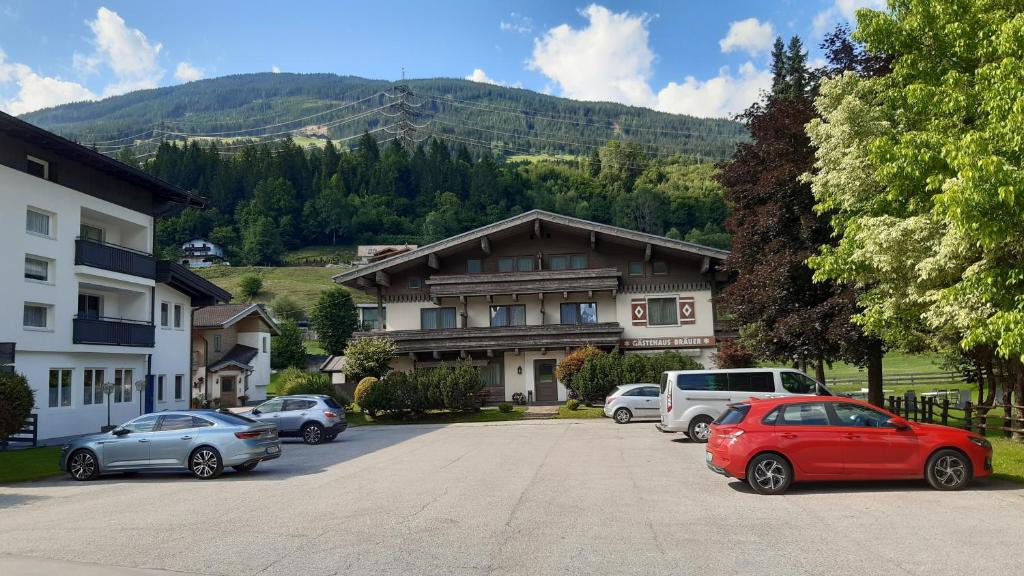 a parking lot with cars parked in front of a building at Gästehaus Bräuer in Neukirchen am Großvenediger
