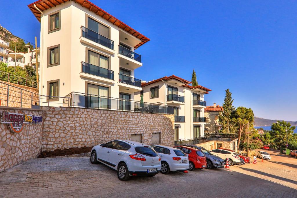 a group of cars parked in front of a building at Happy Kaş Apart in Kaş