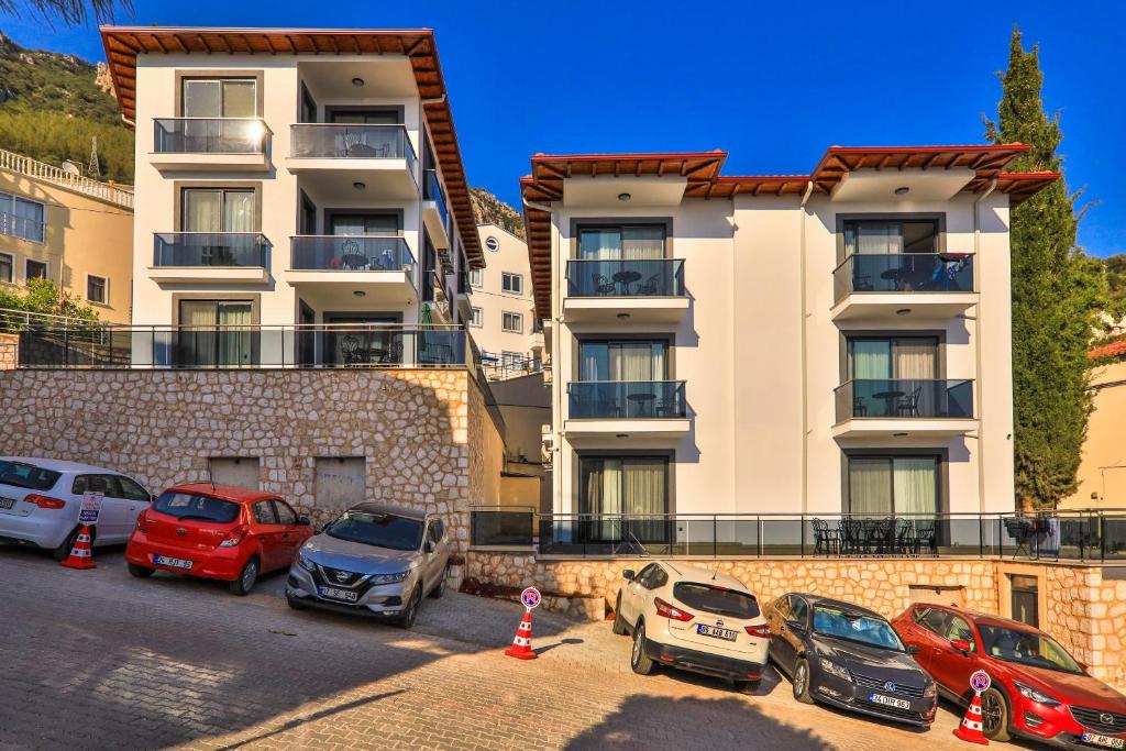 a group of cars parked in front of a building at Happy Kaş Apart in Kaş