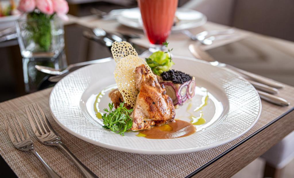 a white plate of food on a table at Waves Aqua Resort in Kenitra