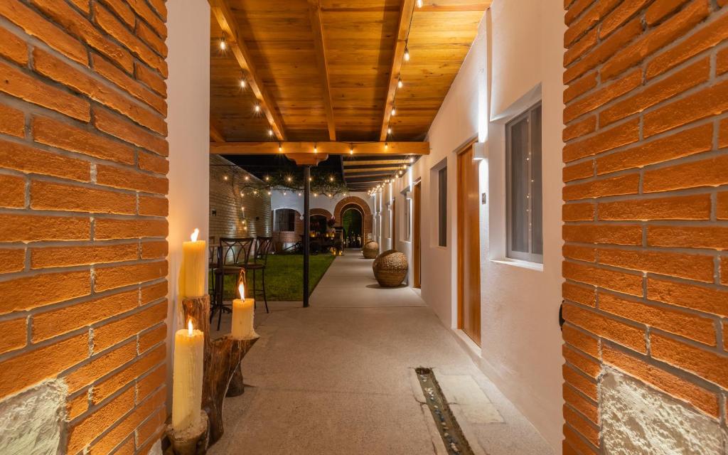 a hallway with candles and a brick wall at ArcoSodi Hotel Boutique in Oaxaca City