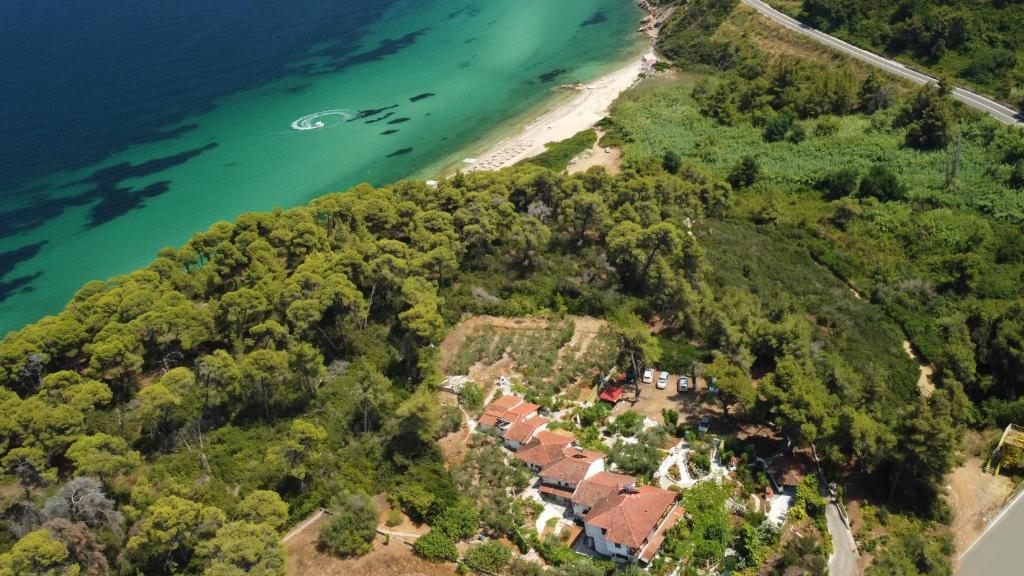 an aerial view of a house on a hill next to the ocean at La Mirage in Nea Fokea