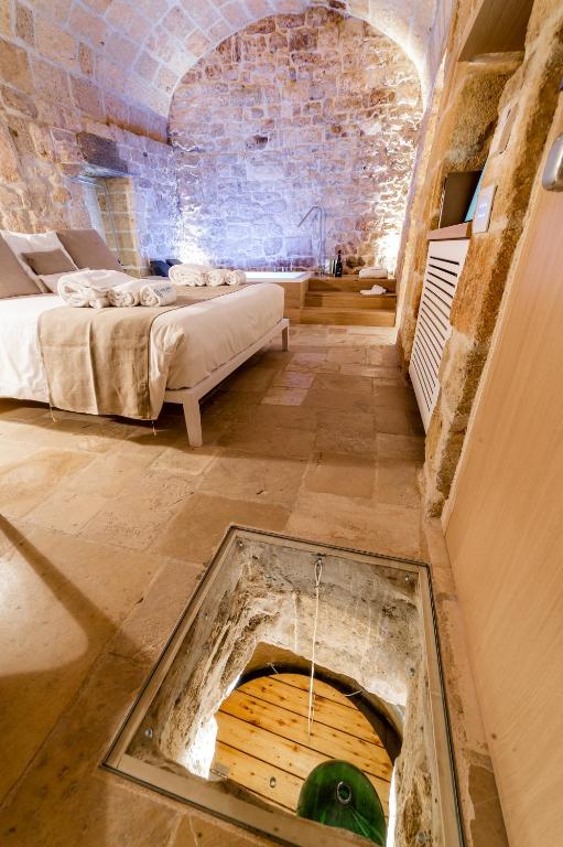 a room with a tub in the middle of a room at Tre Archi Suite & Relais in Polignano a Mare