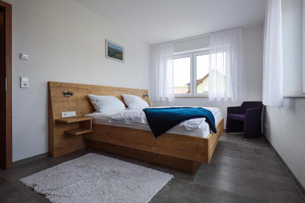 een slaapkamer met een bed met een blauwe deken erop bij Ferienwohnung Volkacher Str.10 in Nordheim