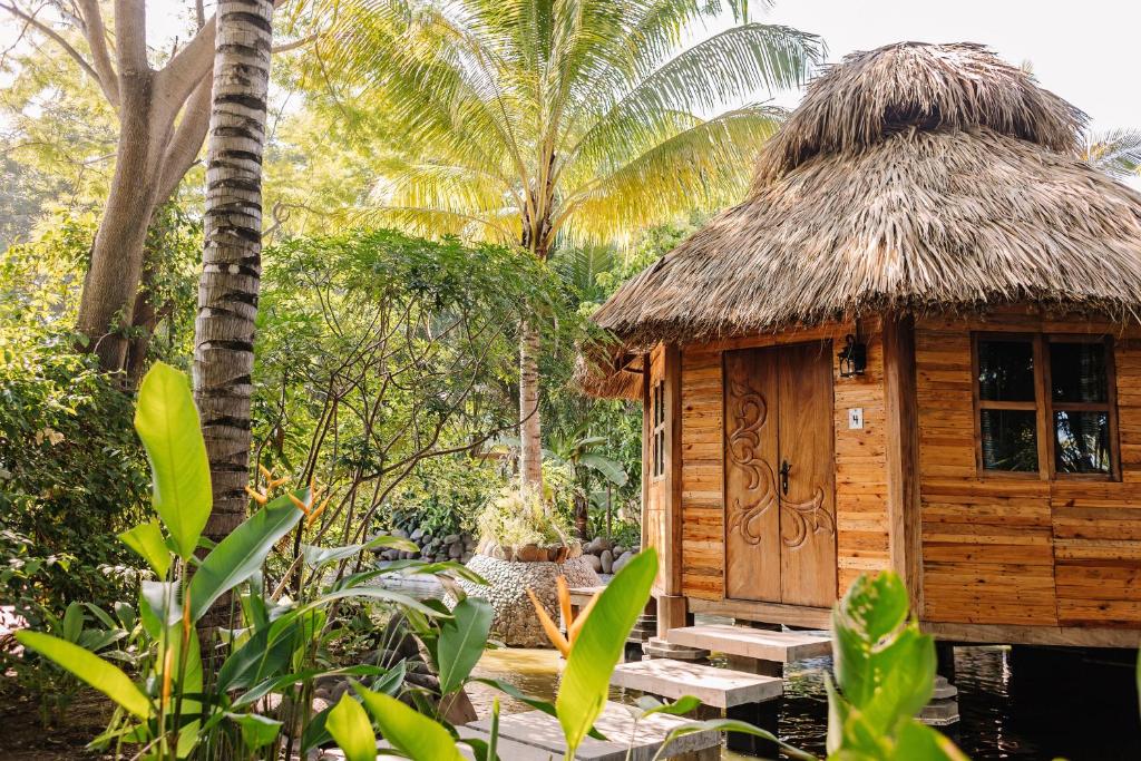 a small wooden hut with a wooden table and chairs at Mandala Eco Villas in La Libertad
