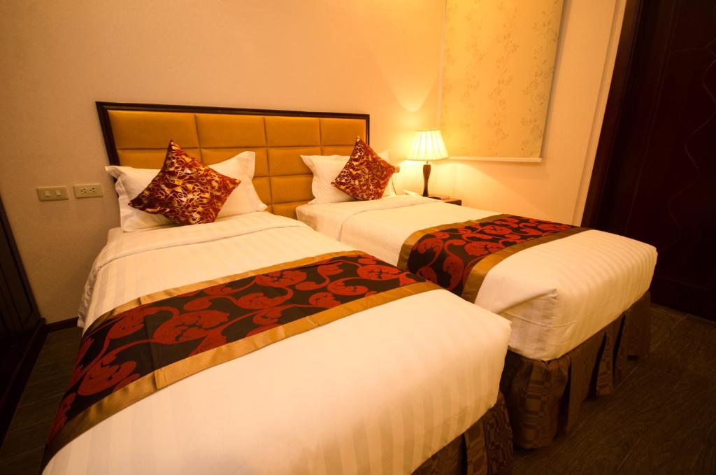 Postel nebo postele na pokoji v ubytování Palawan Uno Hotel
