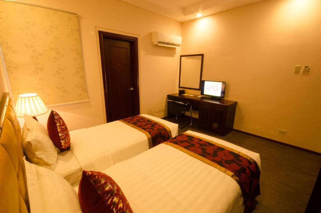 Postel nebo postele na pokoji v ubytování Palawan Uno Hotel