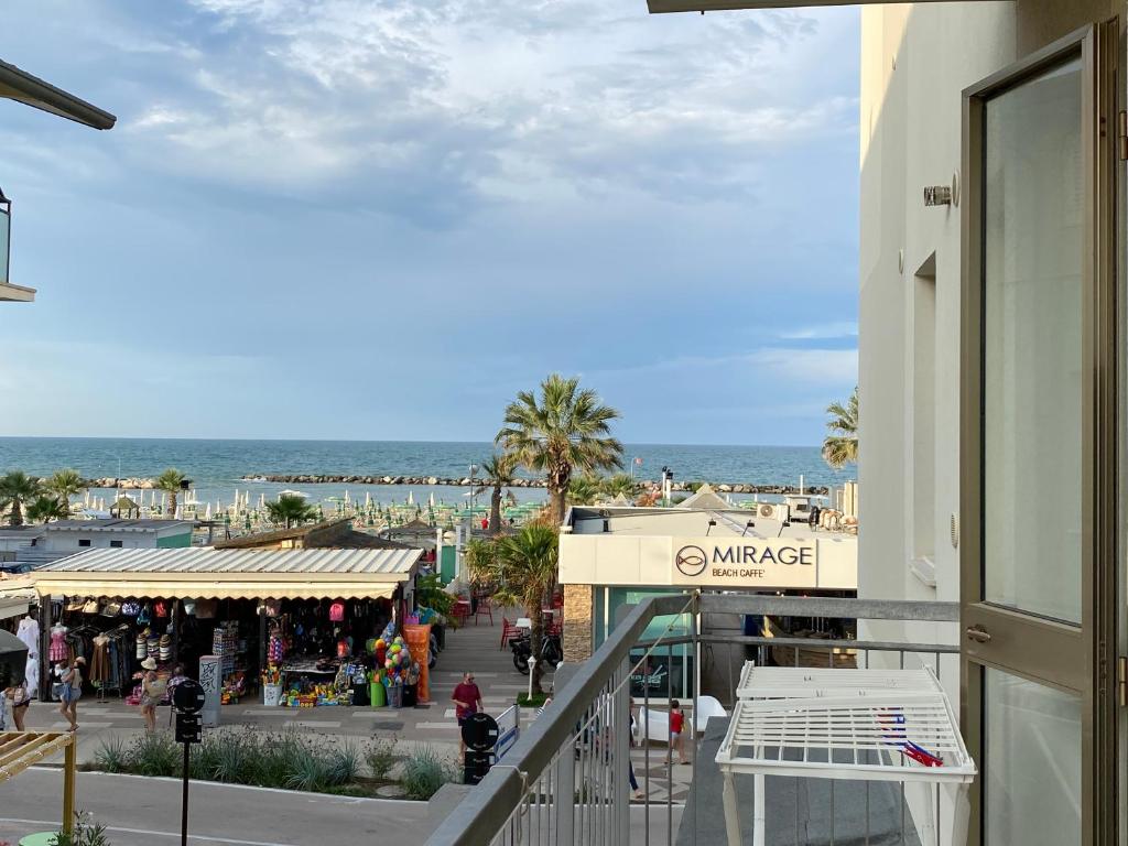 a balcony of a building with a view of a market at Favolosa Vista Mare in Rimini