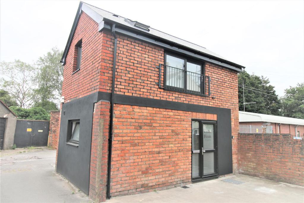 a brick building with a window and a door at The Coach House - Free Private Parking - by Property Promise in Cardiff