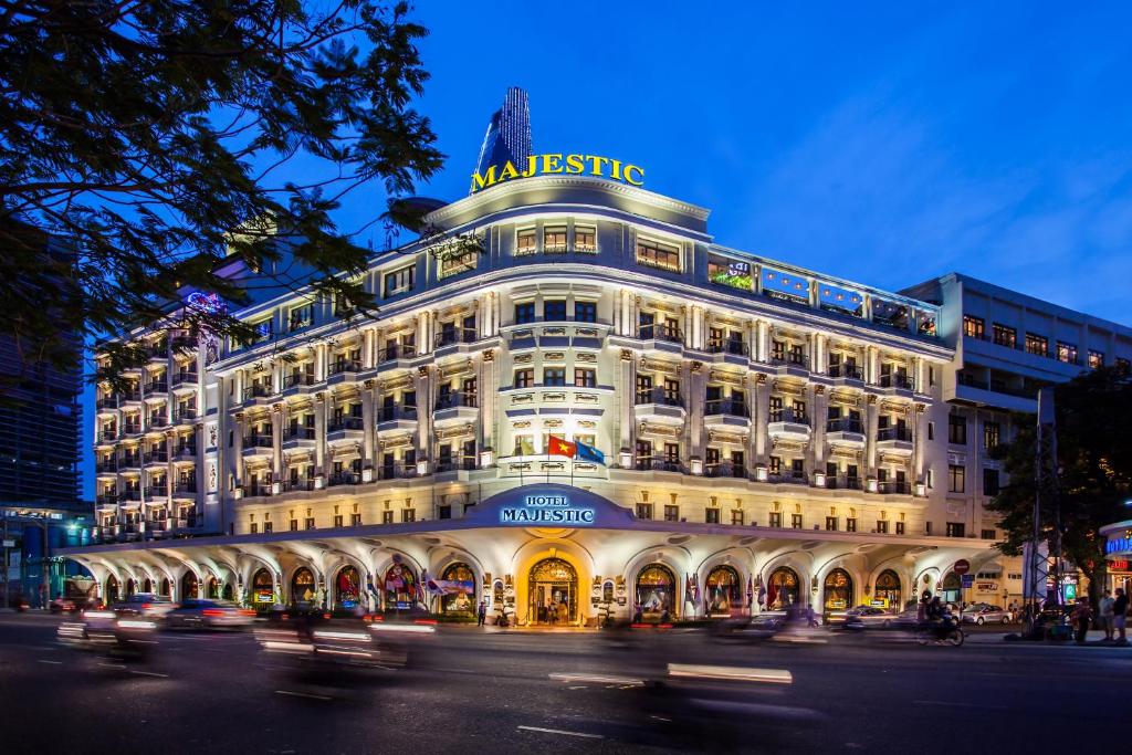 a large white building with a sign on top of it at Hotel Majestic Saigon in Ho Chi Minh City