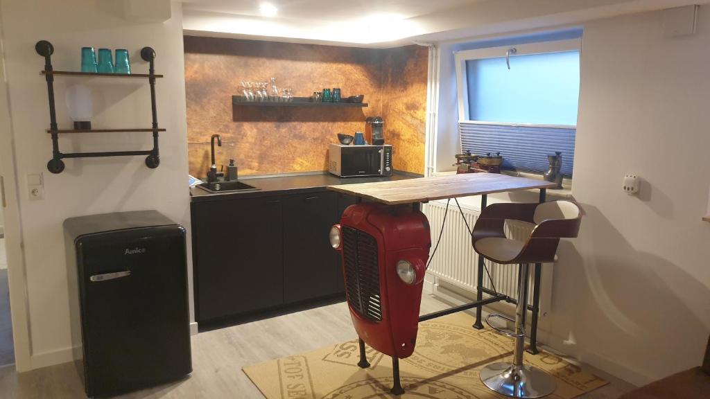 a kitchen with a counter and a kitchen with a stove at Appartement Bühl, zentral und ruhig, Soutterain in Bühl