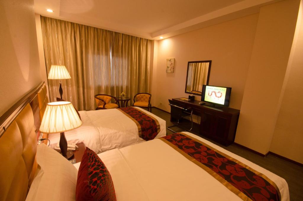 Postel nebo postele na pokoji v ubytování Palawan Uno Hotel