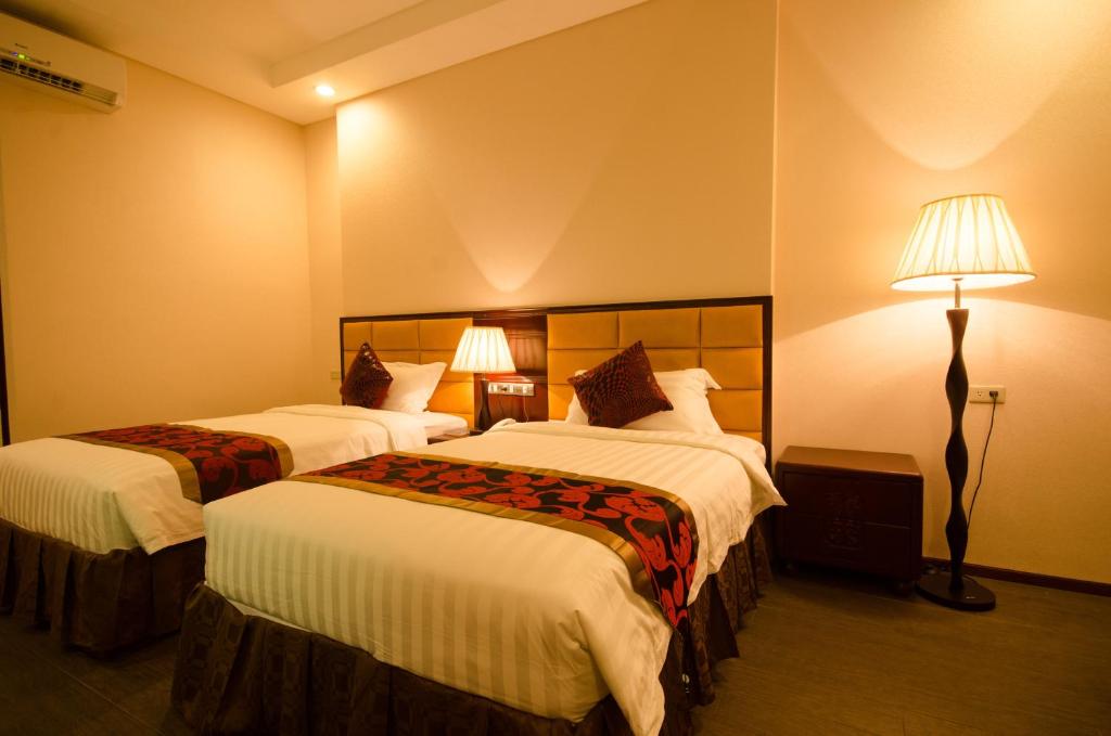 Postel nebo postele na pokoji v ubytování Palawan Uno Hotel