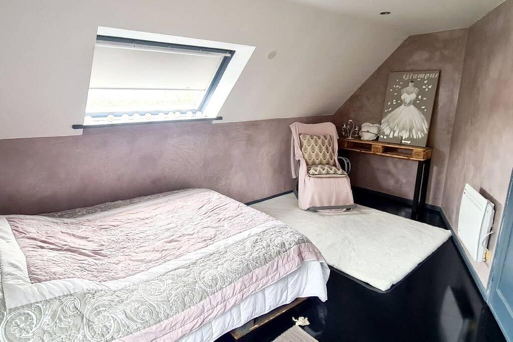 a small bedroom with a bed and a chair at Bienvenue à Soledad notre havre de paix in Étaples
