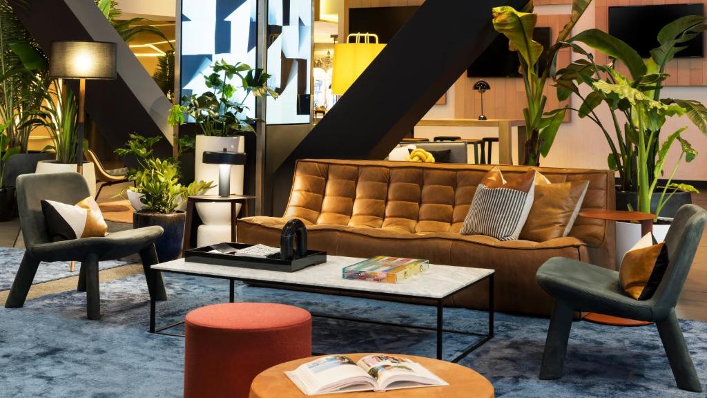a living room with a couch and a coffee table at M Social Hotel Times Square New York in New York