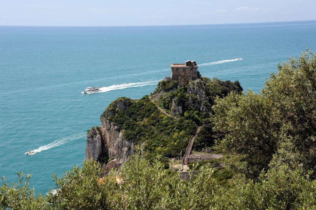 a castle on top of a mountain in the ocean at Hotel Belvedere in Conca dei Marini