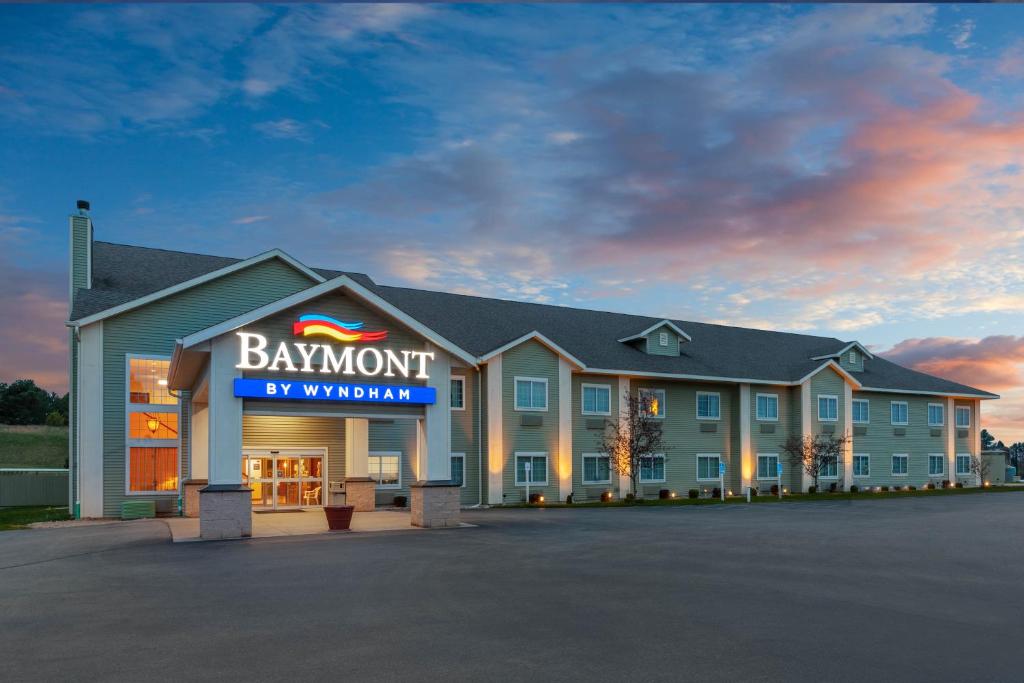 a large building with a sign on the front of it at Baymont by Wyndham Beulah in Beulah