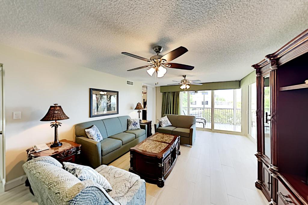 a living room with a couch and a ceiling fan at Duck Key Bliss in Duck Key
