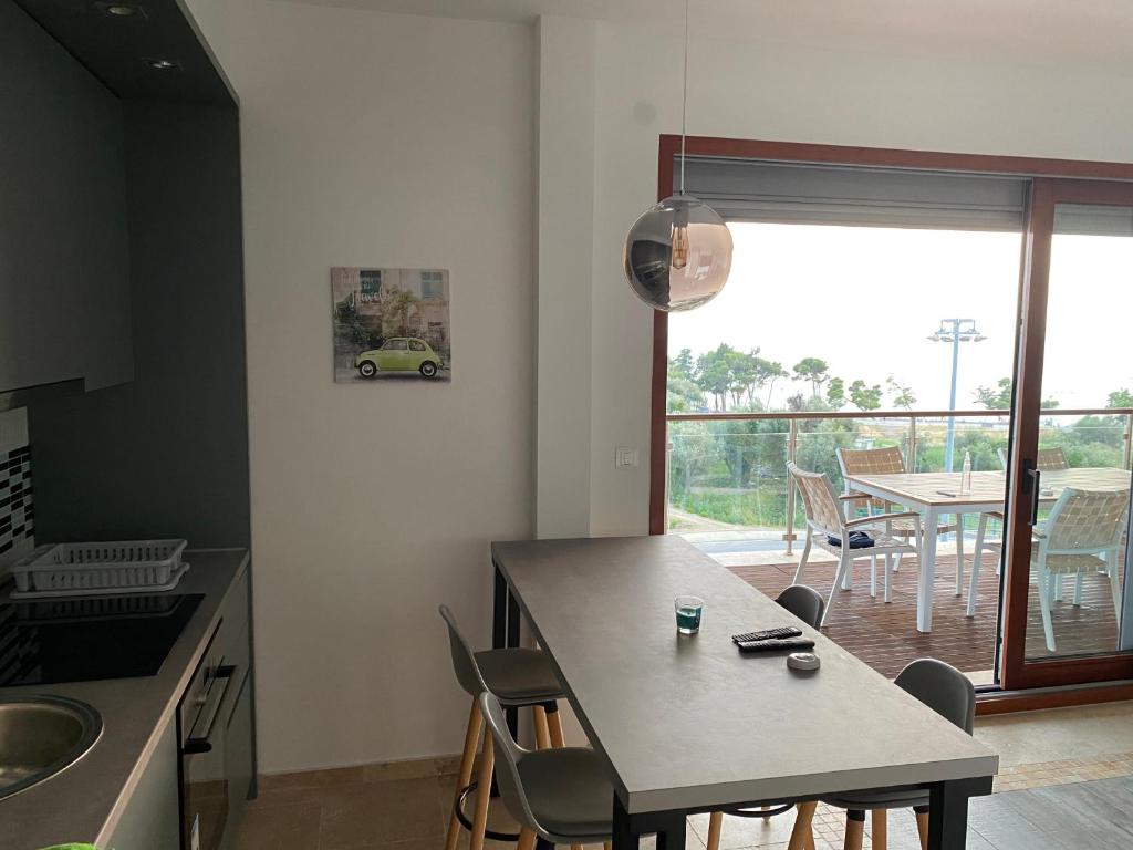a kitchen with a table with chairs and a dining room at Bitcoin and Ethereum Deluxe Apartments in Bar