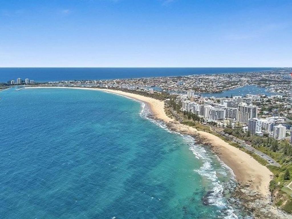 an aerial view of a beach with buildings and the ocean at Seaview 31 Luxurious Beachside Two Bedroom Apartment in Seaview Resort with Stunning Views in Mooloolaba