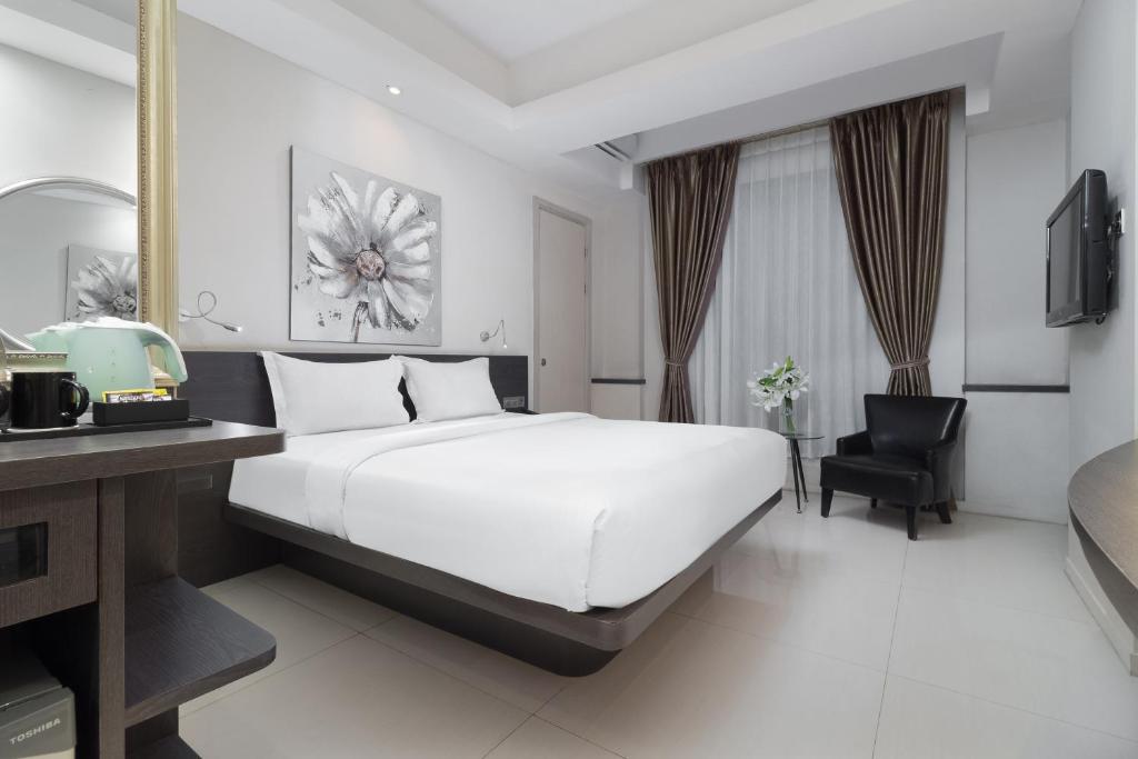 Postel nebo postele na pokoji v ubytování Sun Boutique Hotel