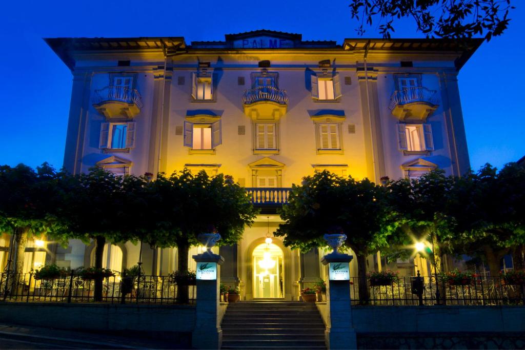 a large white building with stairs in front of it at Hotel Alexander Palme in Chianciano Terme