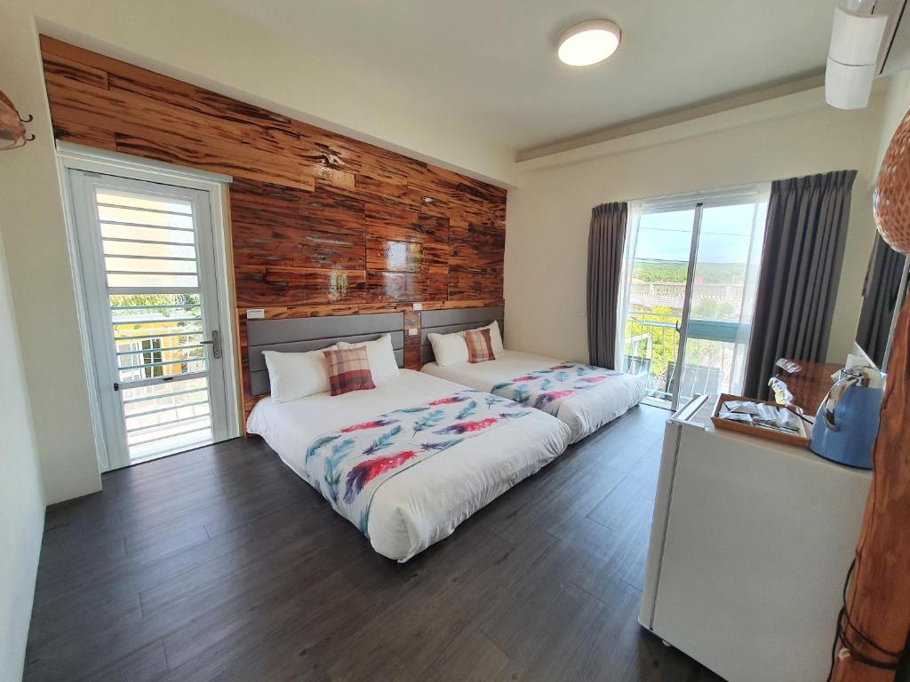 Postel nebo postele na pokoji v ubytování Inn巷文創旅店 Inn siang B&B-墾丁夢幻島