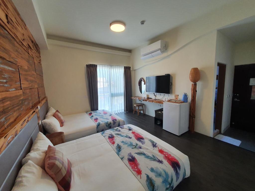 Postel nebo postele na pokoji v ubytování Inn巷文創旅店 Inn siang B&B-墾丁夢幻島