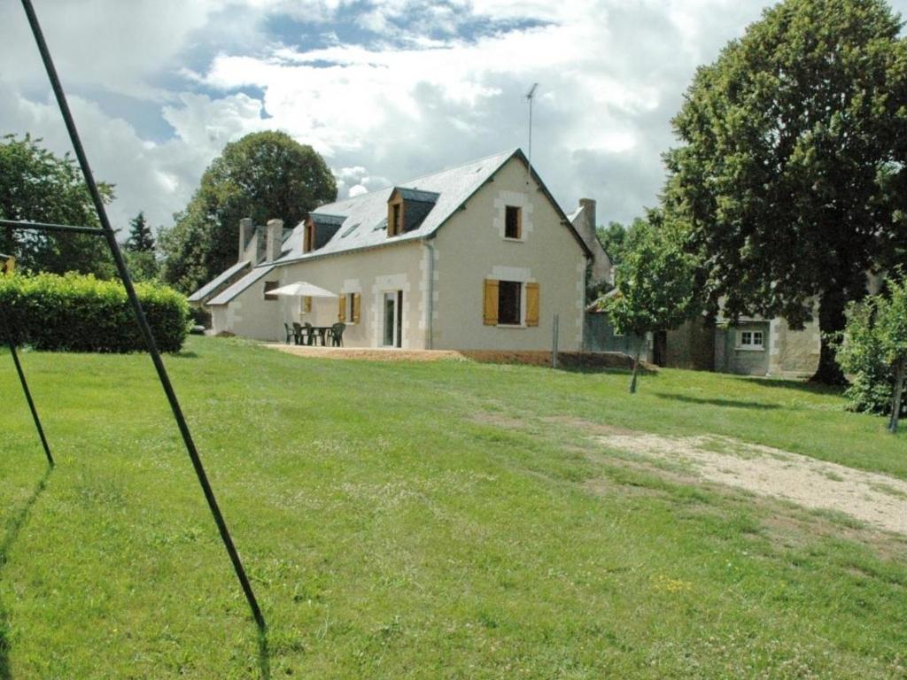 une grande maison blanche avec une cour en herbe dans l'établissement Gîte Chemillé-sur-Indrois, 4 pièces, 7 personnes - FR-1-381-375, à Chemillé-sur-Indrois