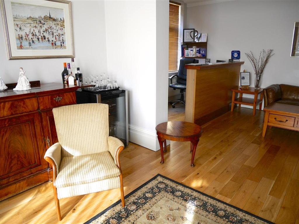 a living room with a chair and a table at The Redstone Guesthouse in Blackpool