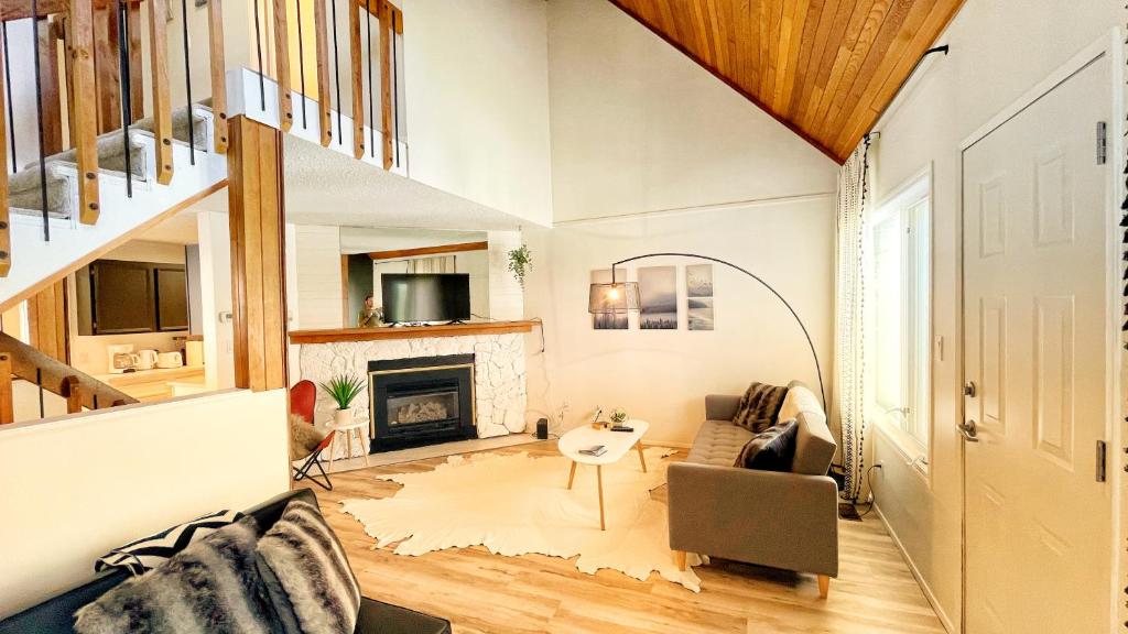 a living room with a staircase and a fireplace at Silver Birch by FantasticStay in Kimberley